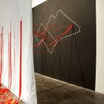 Bloodlines, an installation comprised of ribbon, wall, and scrim